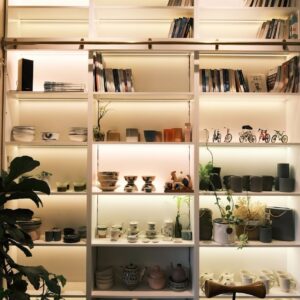 Manual retyping for orders Shelves filled with books and decorative items.