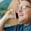 Answering phone calls Man with glasses talking on a smartphone